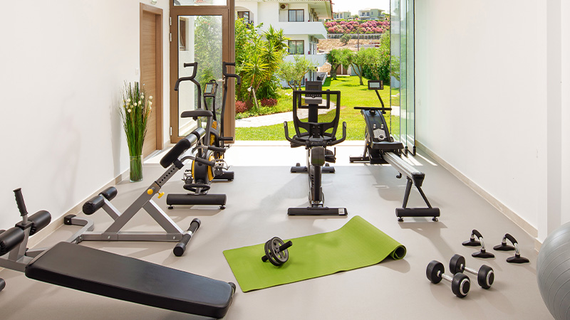 woman writing in notebook at wooden desk with laptop in bright modern workspace with plants and decorative items 7 tips for productivity