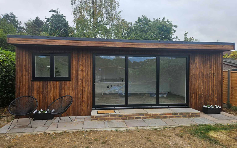 wooden structure with open sections and construction materials visible outside representing home improvement project using 11 materials for renovation