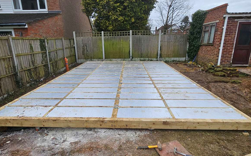 interior view of a partially built structure with wooden framing and unfinished walls showcasing a spacious layout ideal for 7 day construction projects