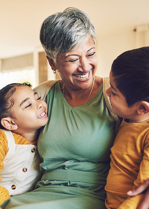 grandmother smiling with two children enjoying family moments together happy memories