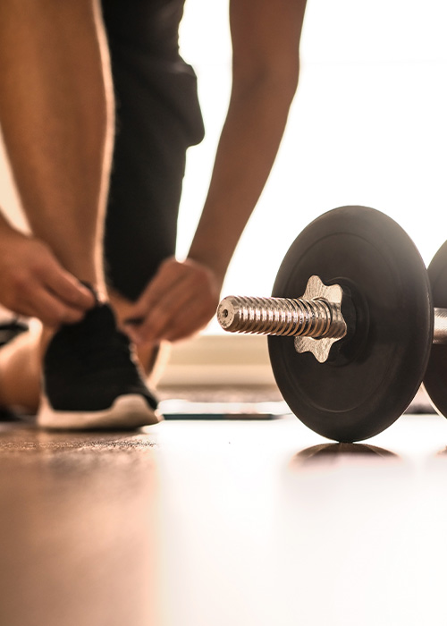 modern gym interior with wooden accents featuring exercise equipment such as a rowing machine and weight bench designed for fitness enthusiasts and workout routines